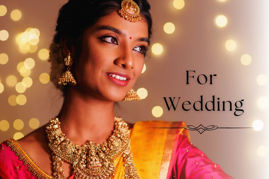 Woman adorned in traditional Indian wedding attire with gold jewelry, with text "For Wedding".