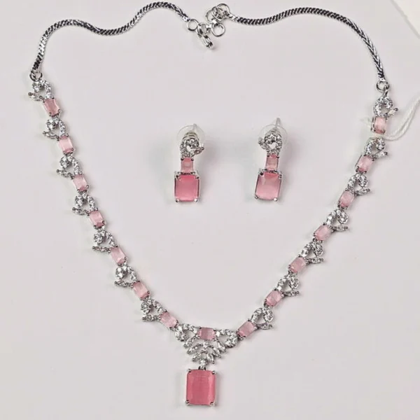 Silver necklace with pink gemstones and matching earrings displayed on a white background.